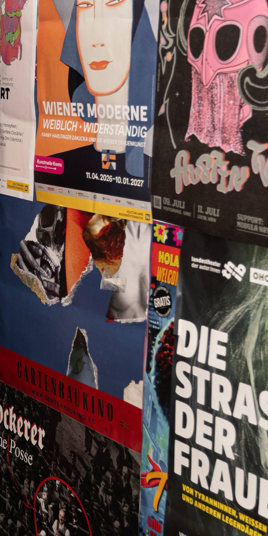 A Vienna wall layered with overlapping screen-printed event posters.